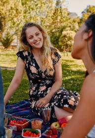 a group of women having a picnic in a park