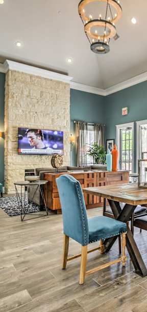 A dining room with a wooden table and chairs.