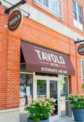 a brick building with a brown awning and a sign that says taylor restaurant and