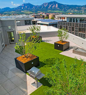 an aerial view of the rooftop of an office building with green grass and trees