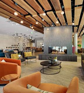 a lobby with couches and chairs and a fireplace