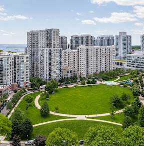A cityscape with a large green park in the middle.