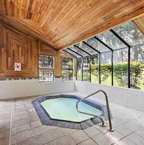 A pool area with a hot tub and a sign that says "SEA RULES".
