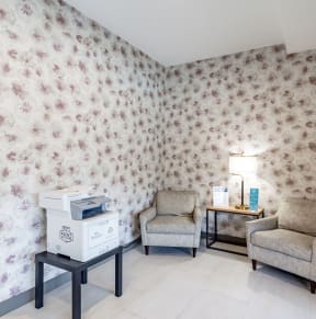 a room with two chairs and a printer