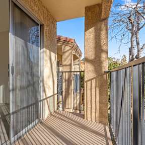 A sunny day at a modern house with a balcony.