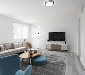 a living room with couches a coffee table and a television