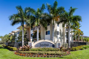 a large building with palm trees in front of it