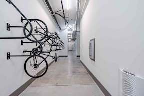 A hallway with bicycles hanging on the wall.