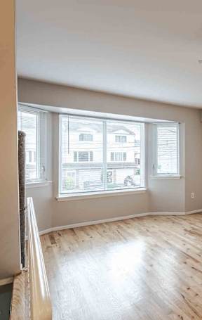 A room with wooden flooring and a ceiling fan at Seaview Apartments in Staten Island, NY, 10305