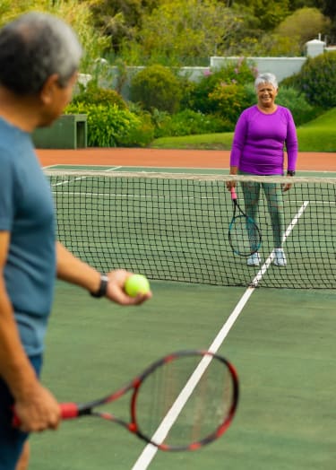 a man and a woman playing tennis on a tennis court