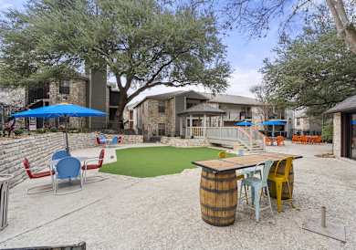 A backyard with a barrel table and chairs.