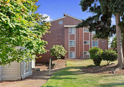 A red brick building with a white door and windows.
