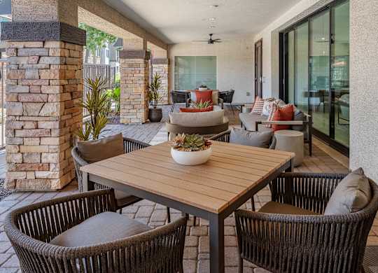 A patio with a table and chairs.