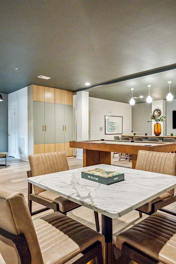 A spacious room with a mirror, exercise equipment, and a television displaying a sunset.