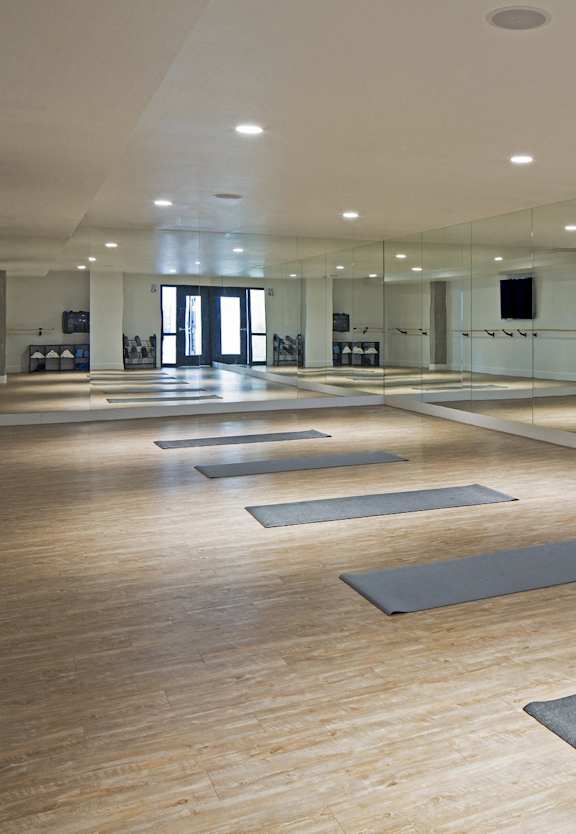 One-Bedroom Apartments in Hollywood, CA - The Fifty Five Fifty - Yoga Studio with Wall Mirrors, Yoga Mats, and High Ceilings