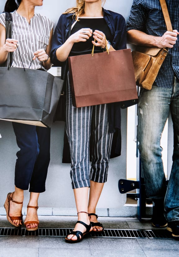 a group of people holding shopping bags