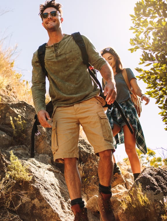 a group of people hiking up a rocky mountain