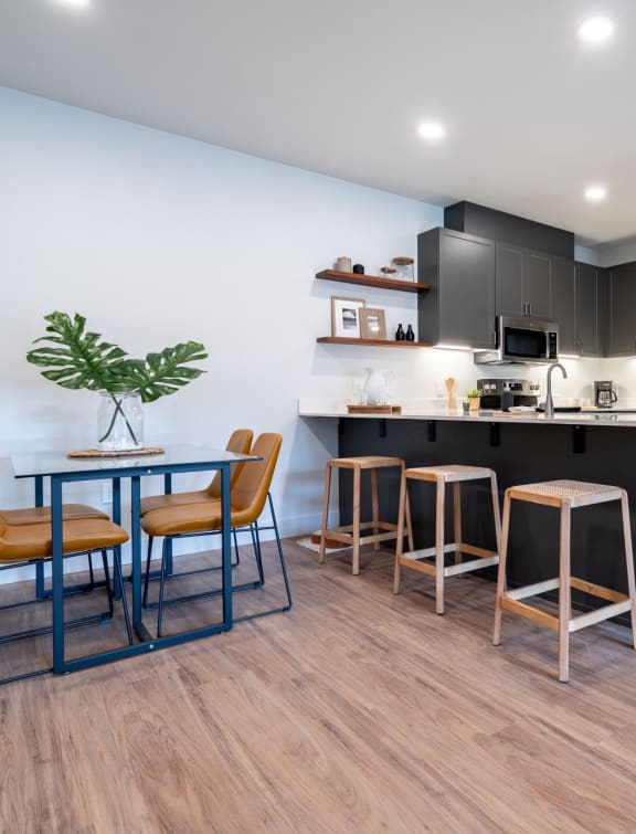 a kitchen and dining area with a table and chairs at Sonder Fields in Happy Valley, OR