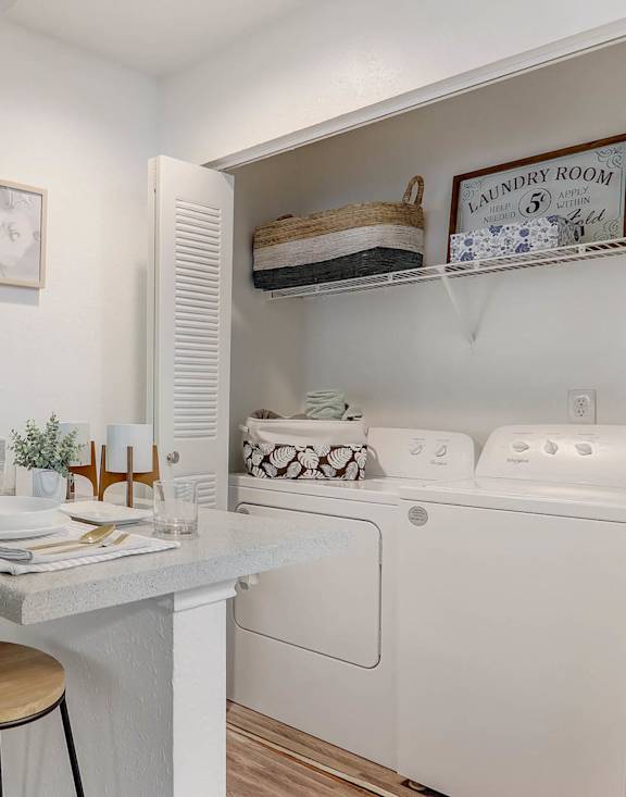 A small laundry room with a washer and dryer.