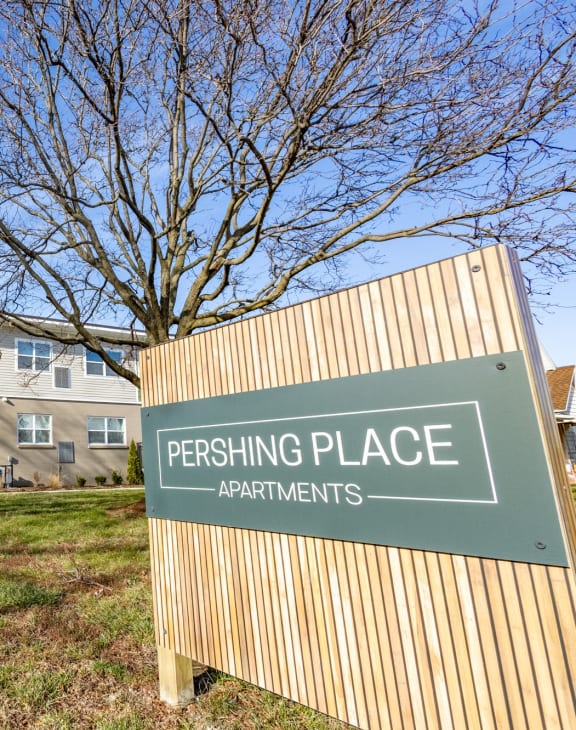 a parking place sign in front of an apartment building