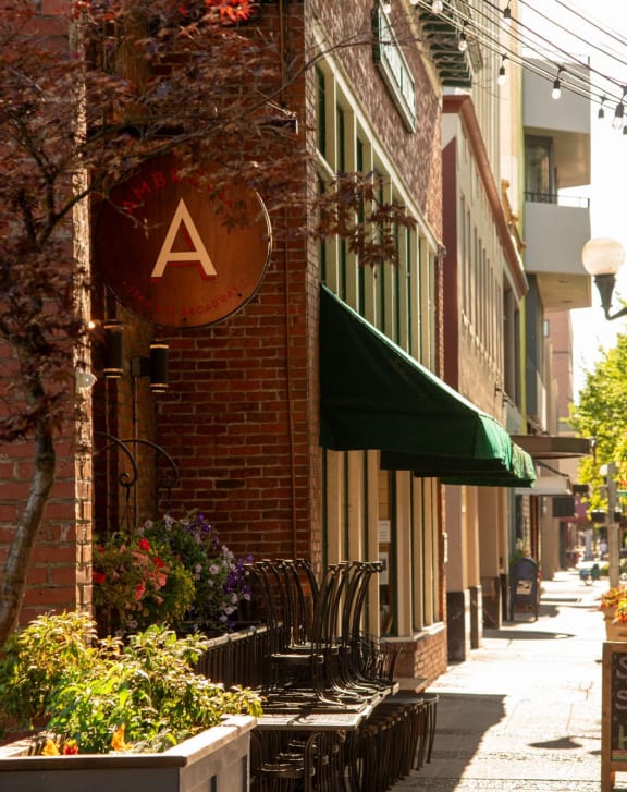 a man and woman walking down a sidewalk with shopping bags