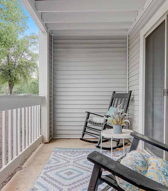 A patio with a chair and table.