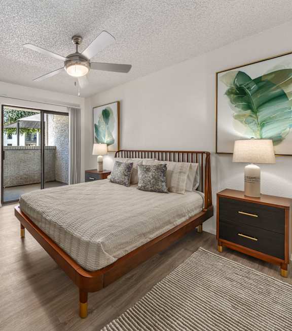 A bedroom with a bed, dresser, and mirror.