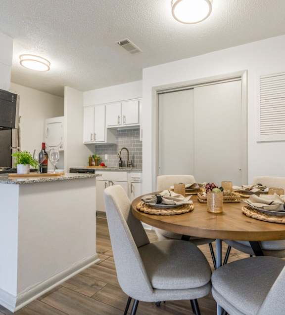 a dining room and kitchen with a table and chairs at Brightwaters Apartments, Arkansas