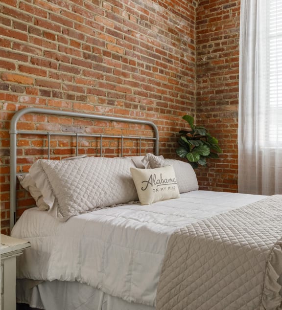 a bedroom with a bed and a large window at The Mill at Prattville, Alabama