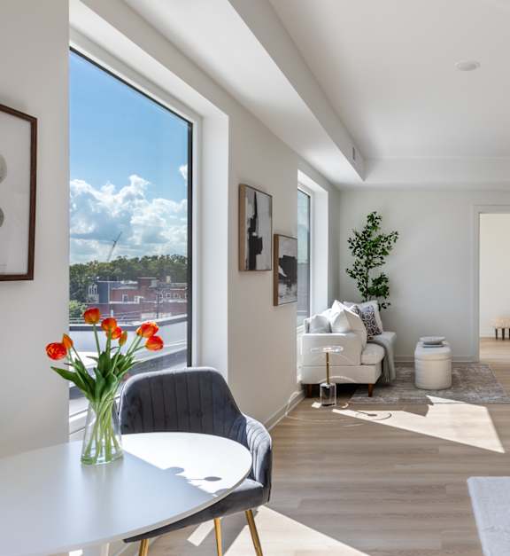 A modern kitchen with a dining table and chairs.