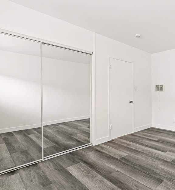 A room with a white door and a sliding glass door.