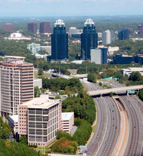 A cityscape with a highway running through it.