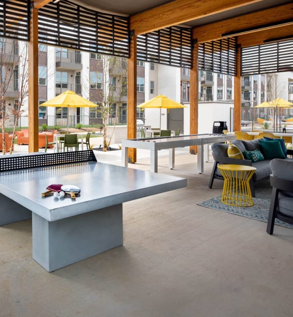 a communal area with a ping pong table in the middle