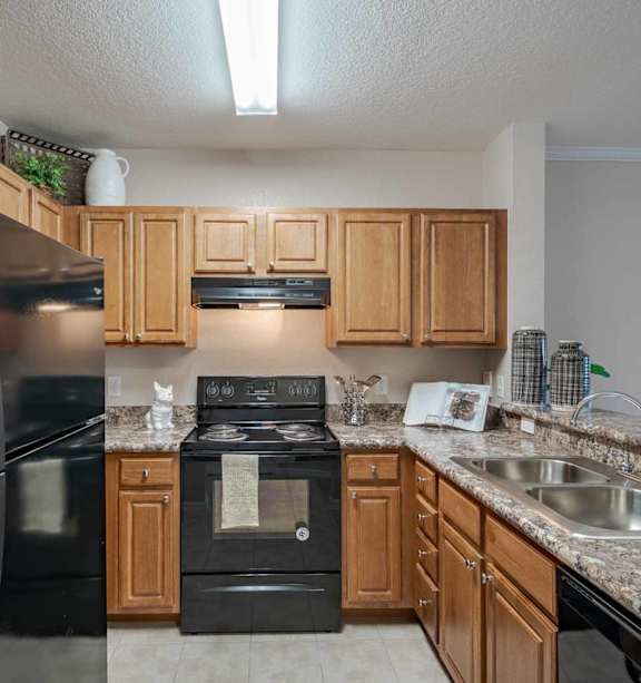 a living room and kitchen with a bar and stools at Audubon Oaks, 33809