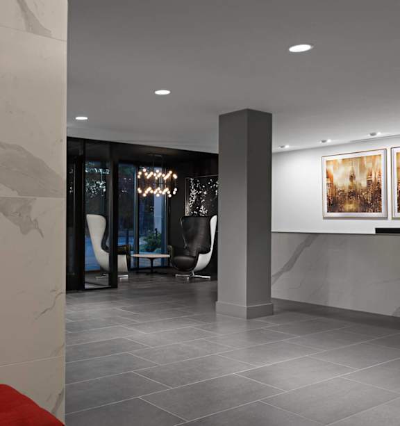 A modern living room with a fireplace and a red couch.