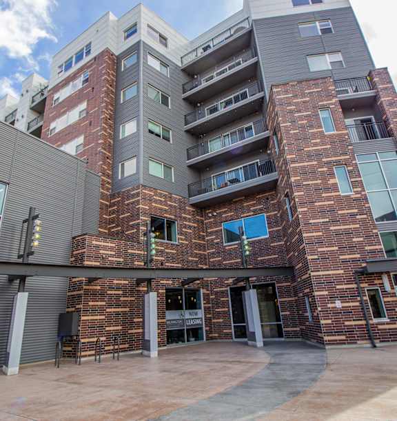 A modern building with a glass facade and a brick exterior at Wilmington Flats Apartments, Salt Lake City, UT