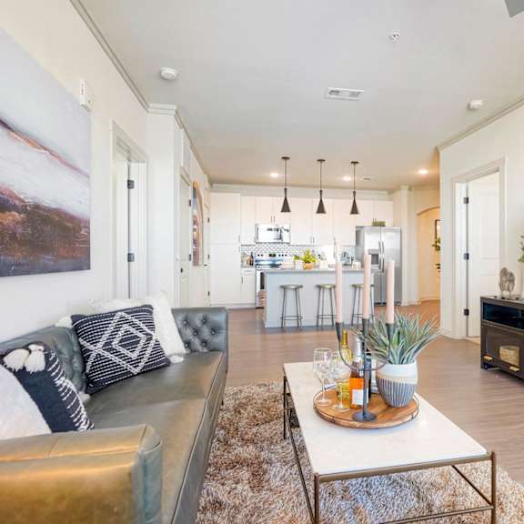 A modern living room with a large couch and a television.