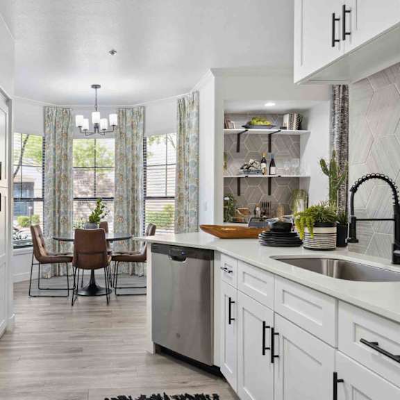 A modern kitchen with a dining table and chairs.