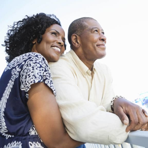 a man and a woman standing on a boat