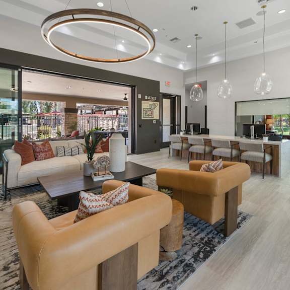 A kitchen with a bar area and a ceiling fan.