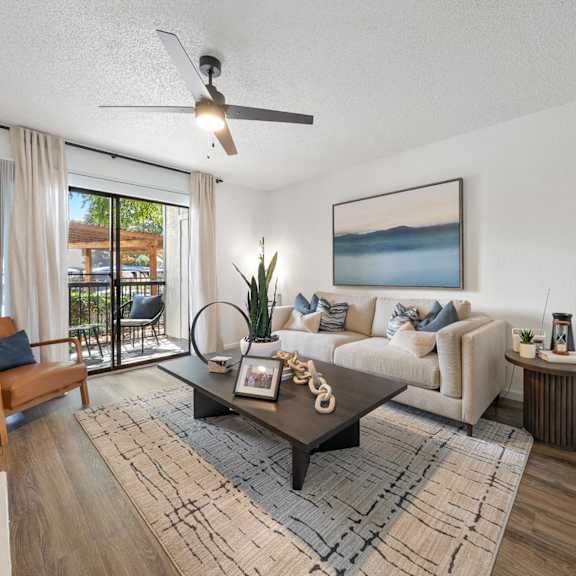 A bedroom with a large bed and a wooden side table.