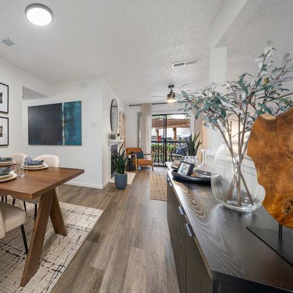 A living room with a fireplace, a couch, a coffee table, and a painting on the wall.