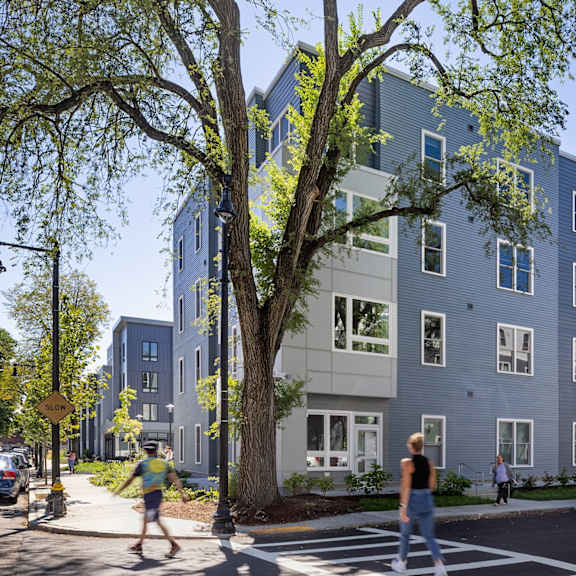 a rendering of an apartment building on a city street at The Anne M. Lynch Homes at Old Colony, Massachusetts, 02127