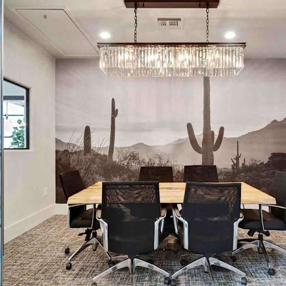 A conference room with a desert mural on the wall.