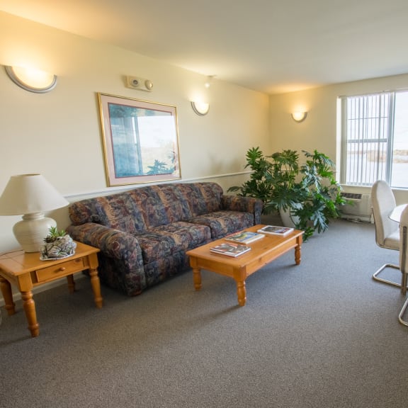 an open concept living room and dining area with a white dining table and rattan chairs