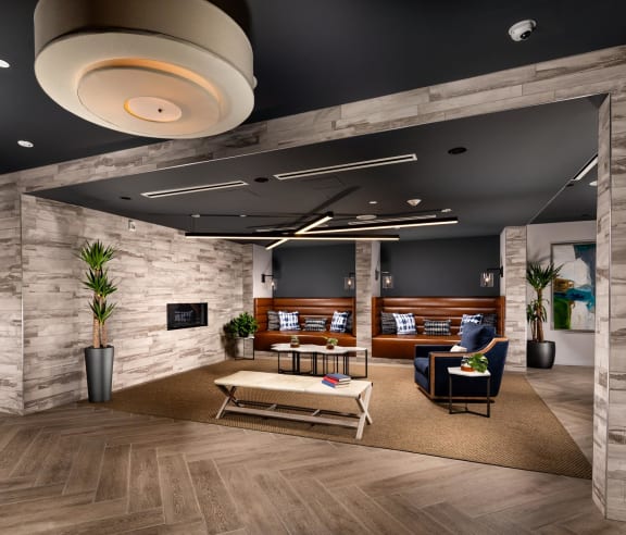 a rendering of a lobby with a stone wall and wood flooring
