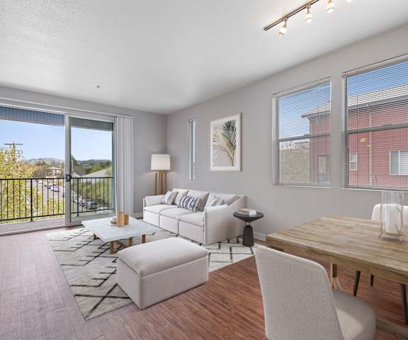 A living room with a sliding glass door leading to a balcony.