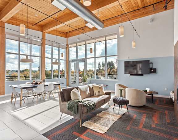 A living room with a couch, chairs, and a television.