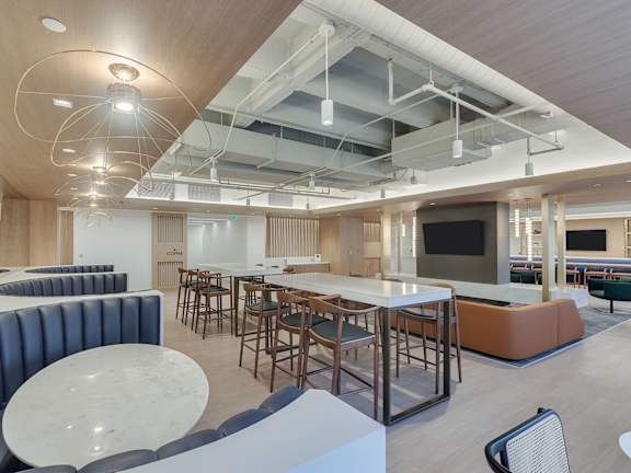 A modern open space with a bar and seating area.