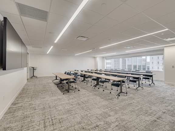 A conference room with a long table and chairs.
